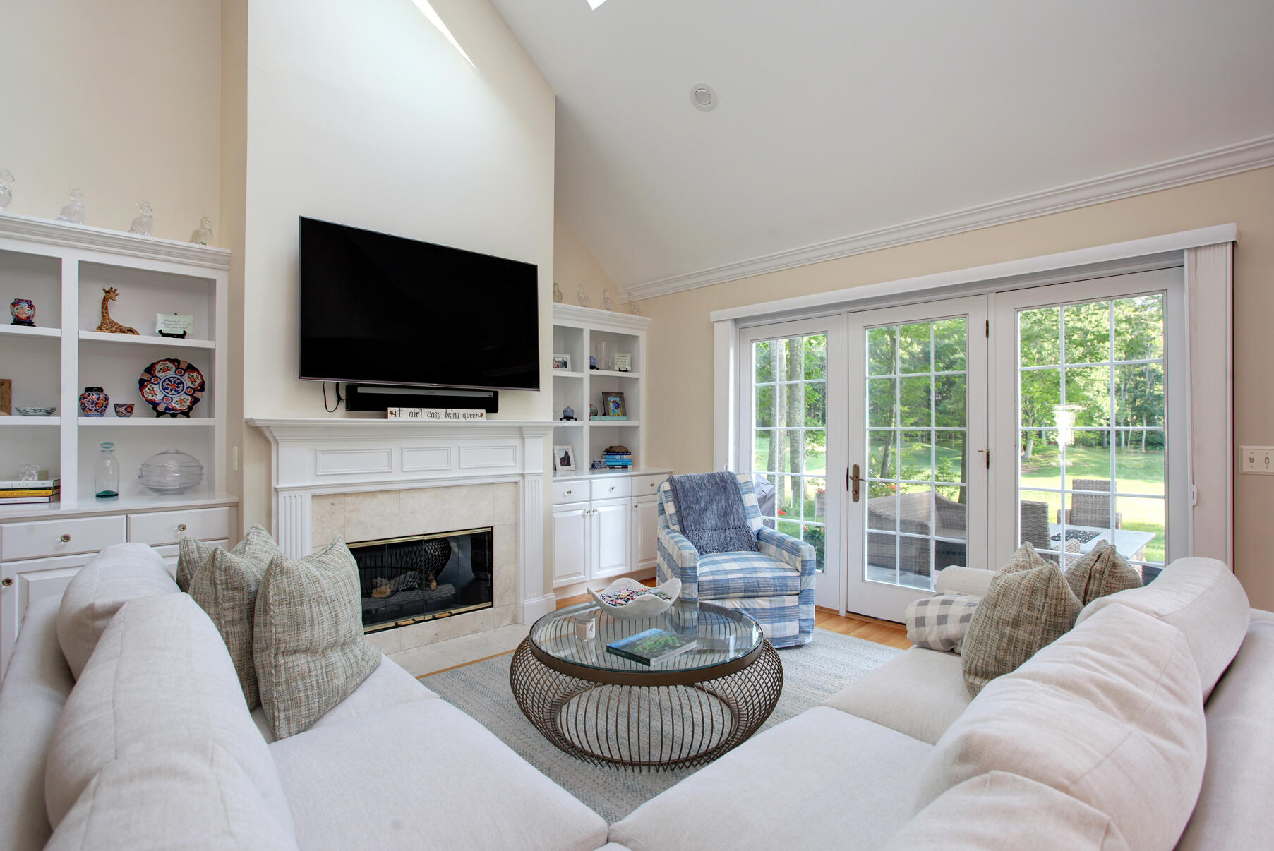 101 Reflection Drive Sandwich, MA 02563 - Photo 9 of 37 a living room with furniture a flat screen tv and a fireplace