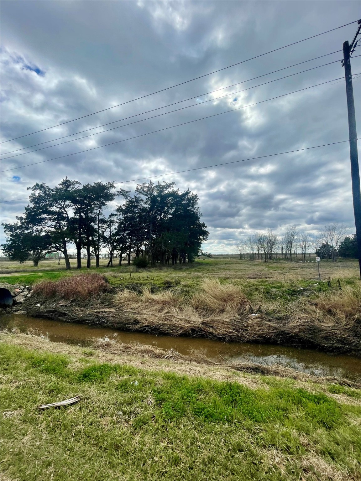 185 8th Street Van Vleck, TX 77482 - Photo 1 of 3 a view of a lake with a big yard