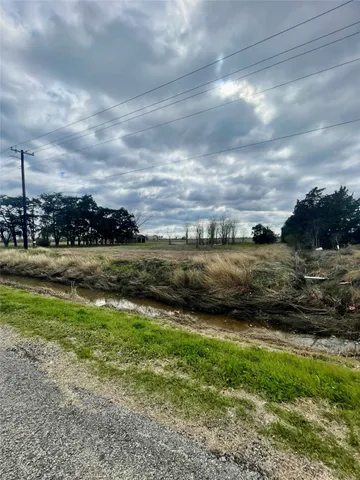 a view of a lake with houses in the back