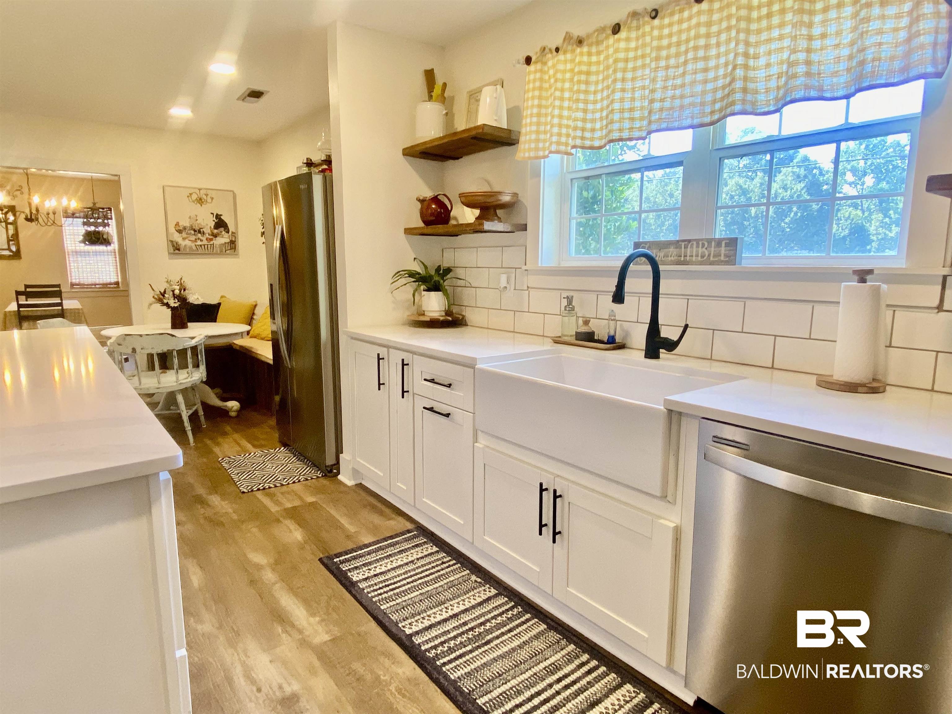 531 Highway 136 Monroeville, AL 36460 - Photo 16 of 48 Kitchen with a healthy amount of sunlight, decorative backsplash, appliances with stainless steel finishes, and light hardwood / wood-style floors