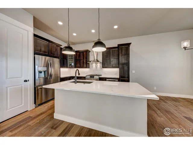 a kitchen with kitchen island a sink and a stove