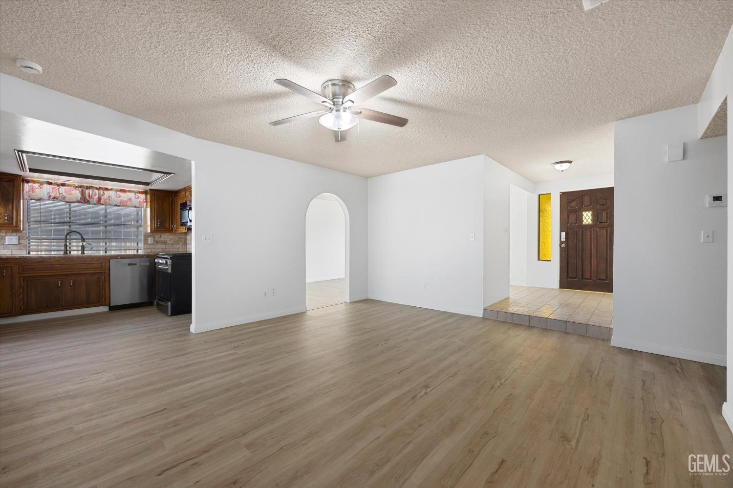 Undisclosed Address Taft, CA 93268 - Photo 11 of 36 a view of an empty room with window and wooden floor