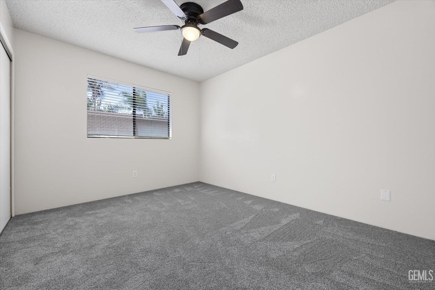 Undisclosed Address Taft, CA 93268 - Photo 21 of 36 an empty room with a window and a fan