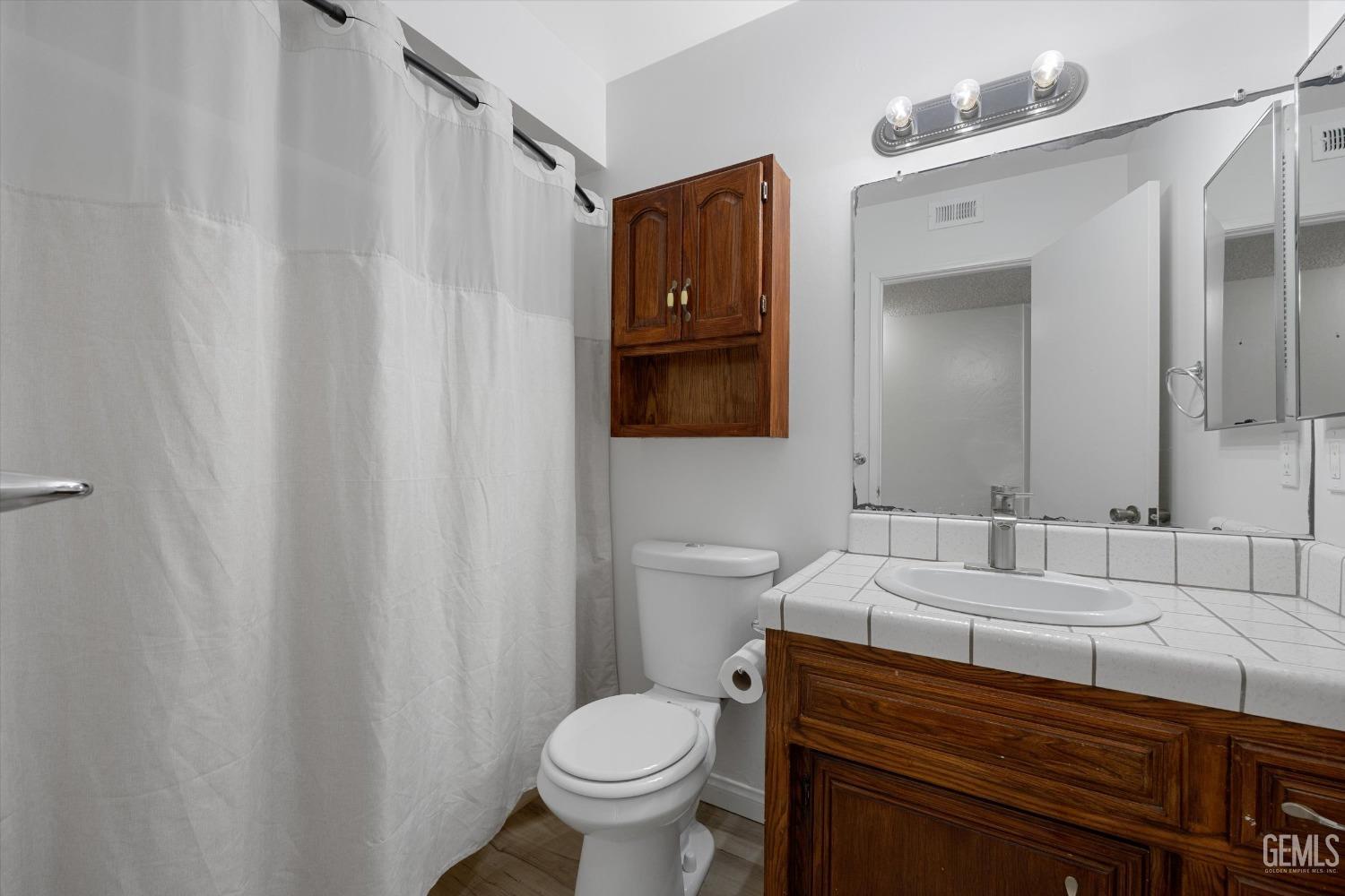 Undisclosed Address Taft, CA 93268 - Photo 23 of 36 a bathroom with a sink toilet and mirror
