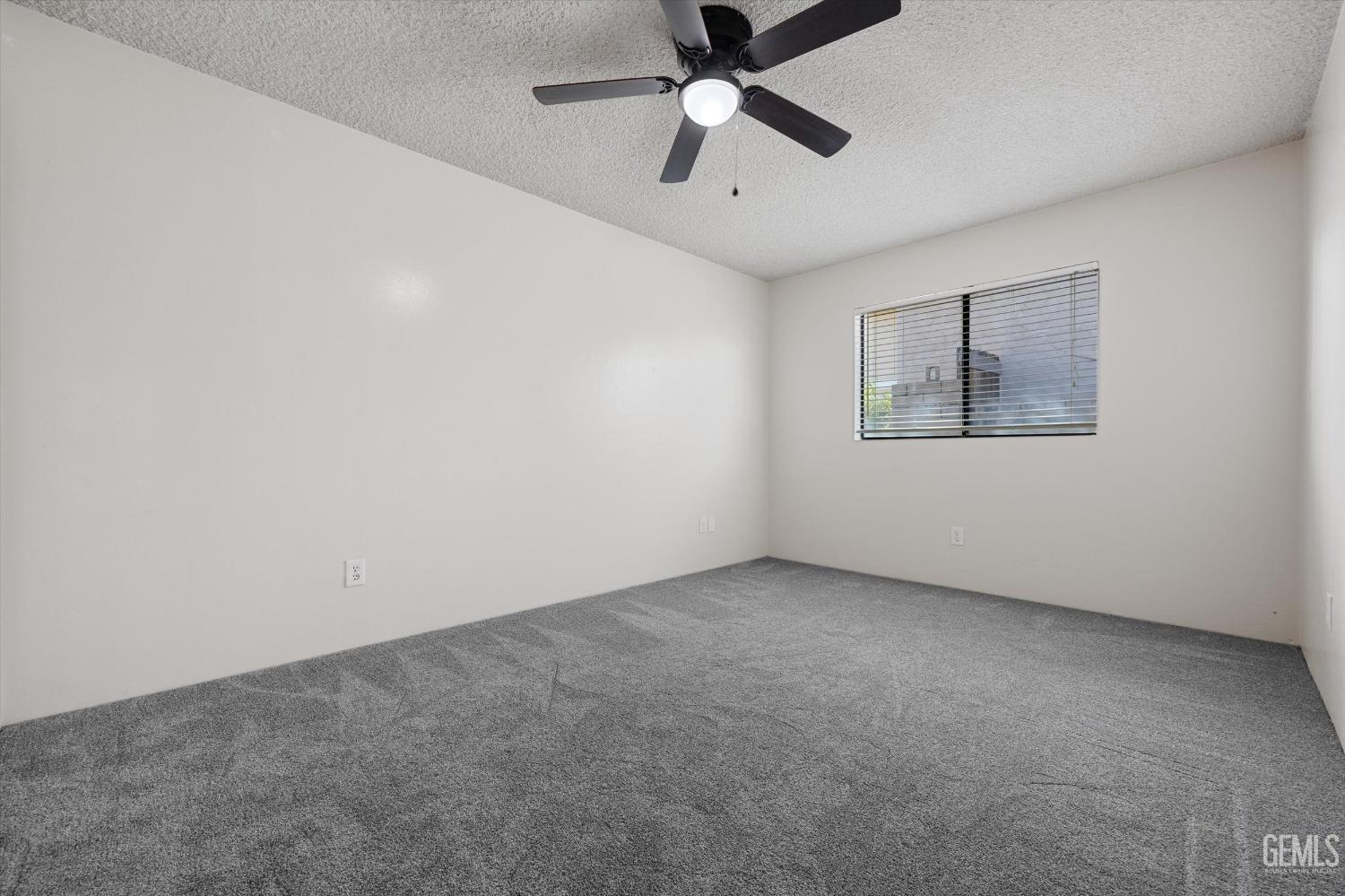 Undisclosed Address Taft, CA 93268 - Photo 26 of 36 an empty room with a ceiling fan and windows
