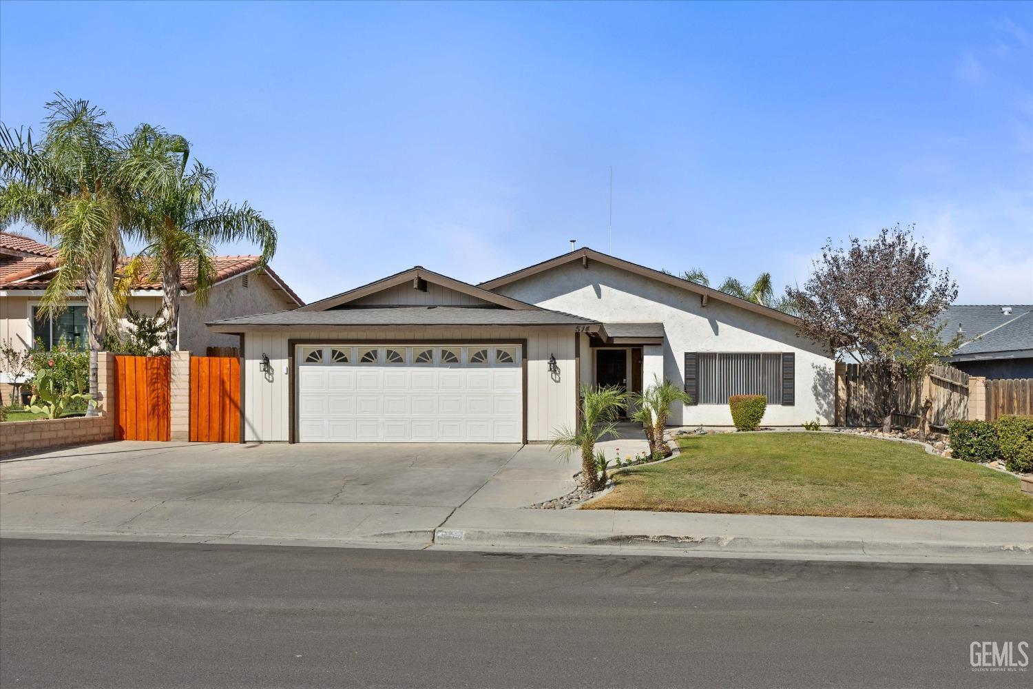 Undisclosed Address Taft, CA 93268 - Photo 3 of 36 a front view of a house with a yard and garage