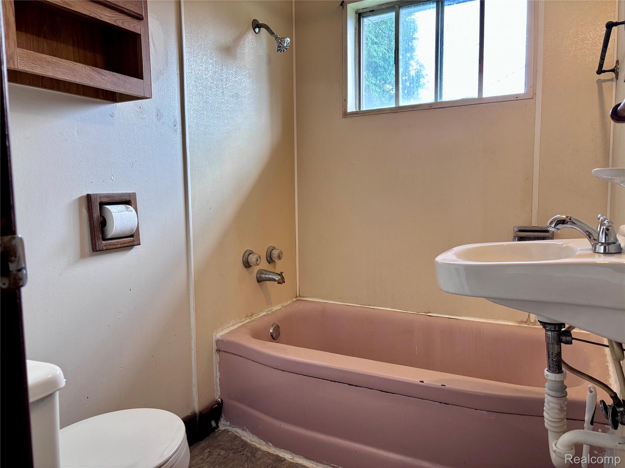 4490 Peppermill Road Attica, MI 48412 - Photo 4 of 19 Wall-mounted sink with chrome faucet, built-in bathtub, and overhead shower fixture