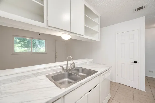 a kitchen with a sink and cabinets