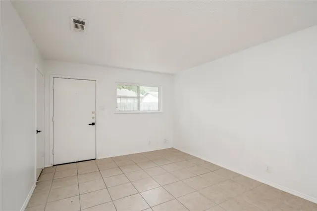a view of an empty room and window