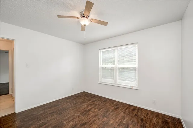 a view of empty room with ceiling fan