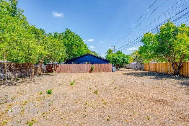 a backyard of a house with a tree
