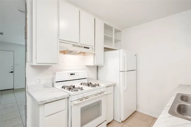 a kitchen with stainless steel appliances white cabinets and a sink