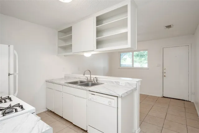 a utility room with sink dryer and washer