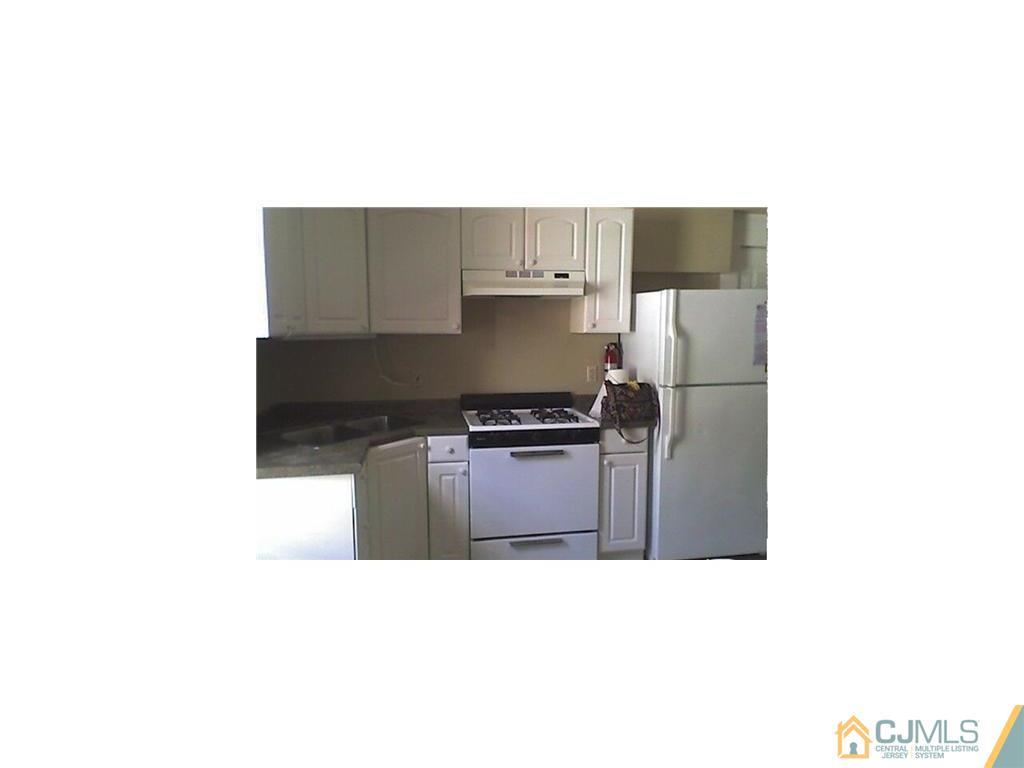 59 Handy Street New Brunswick, NJ 08901 - Photo 4 of 10 a kitchen with a refrigerator and a stove
