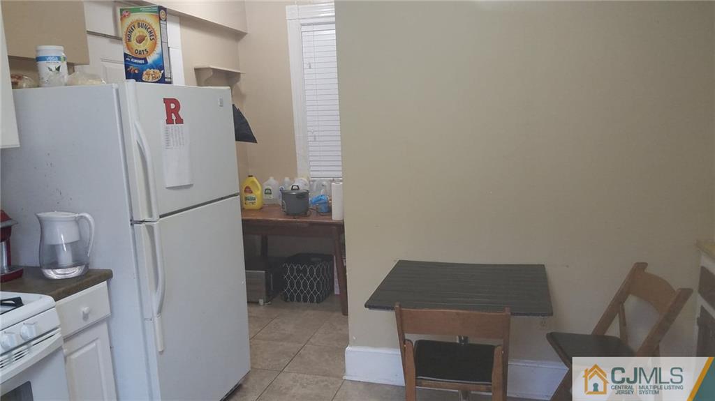 59 Handy Street New Brunswick, NJ 08901 - Photo 5 of 10 a white refrigerator freezer sitting inside of a kitchen