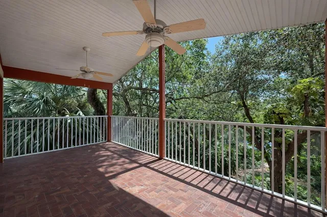 a balcony with trees in front of it