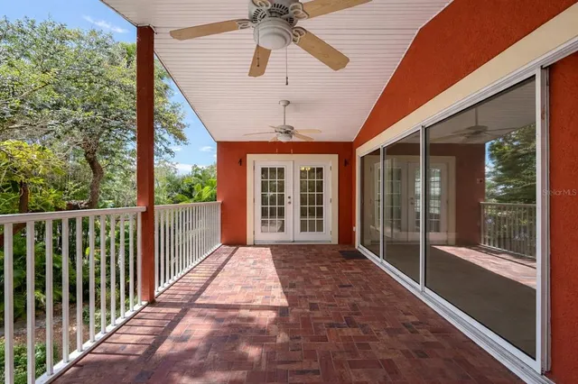 a porch with a table and chairs