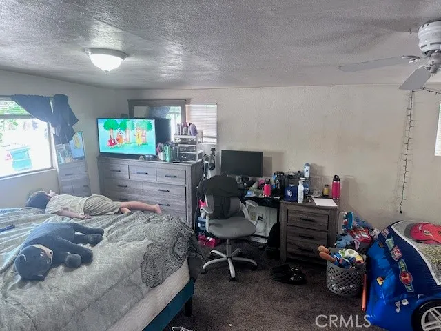 a bedroom with a bed furniture and a flat screen tv