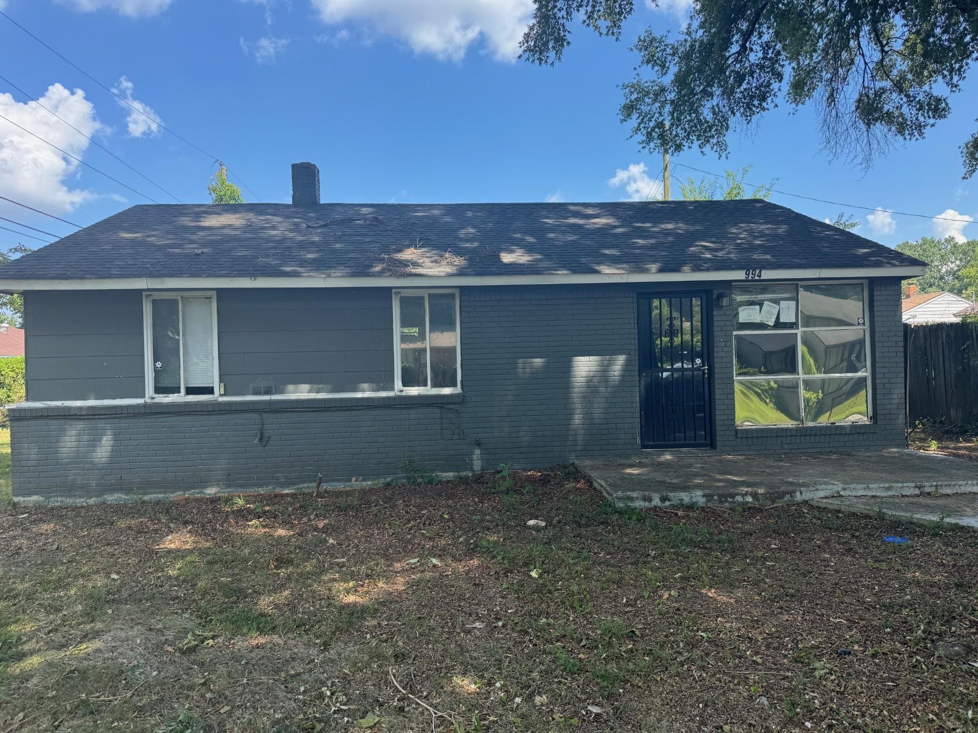 994 North Perkins Road Memphis, TN 38122 - Photo 12 of 15 View of front facade with brick siding, roof with shingles, and a chimney