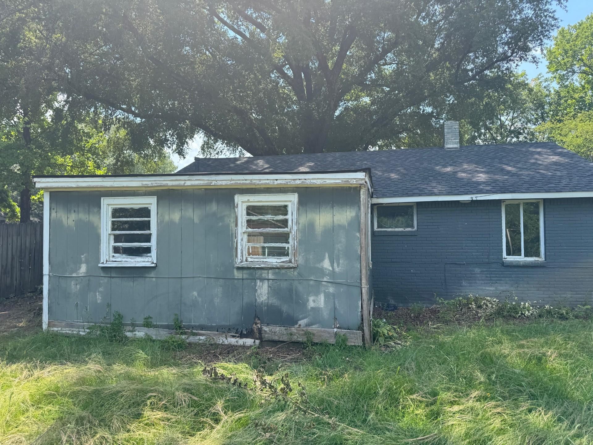 994 North Perkins Road Memphis, TN 38122 - Photo 14 of 15 View of side of home with brick siding, a chimney, and a shingled roof