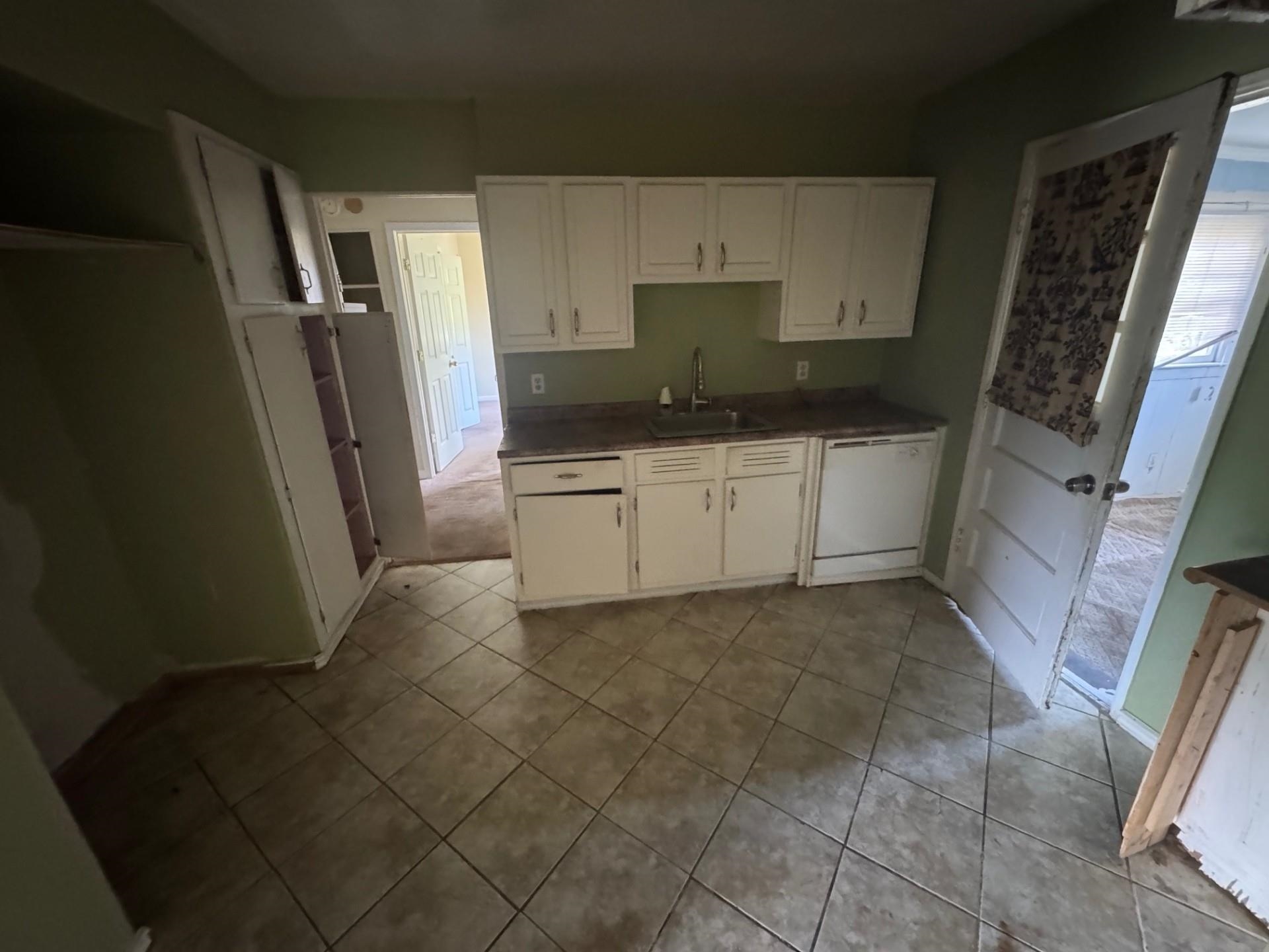 994 North Perkins Road Memphis, TN 38122 - Photo 3 of 15 Kitchen with white cabinetry, white dishwasher, and light tile patterned flooring