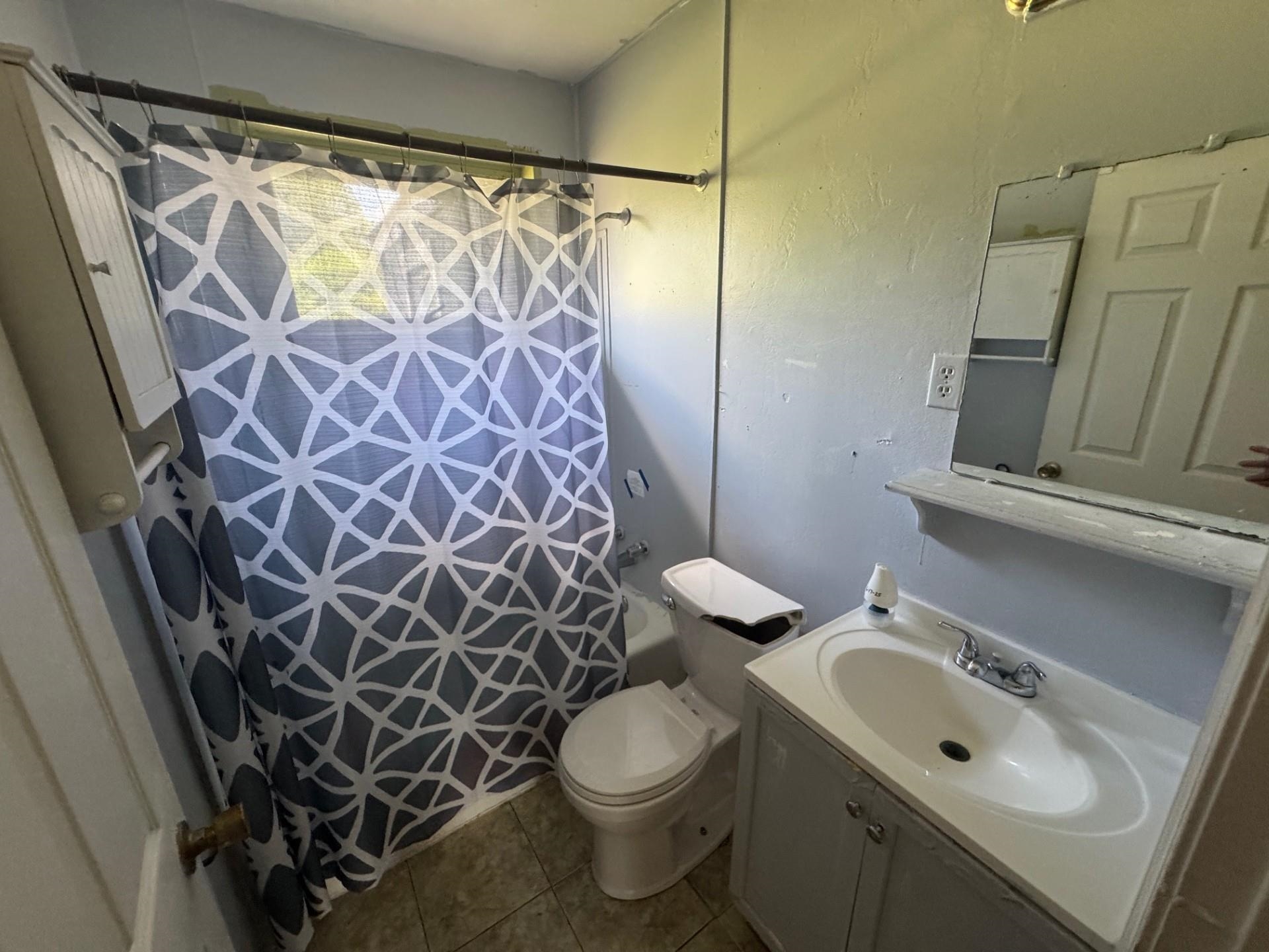 994 North Perkins Road Memphis, TN 38122 - Photo 7 of 15 Bathroom with vanity, shower / bathtub combination with curtain, and tile patterned flooring