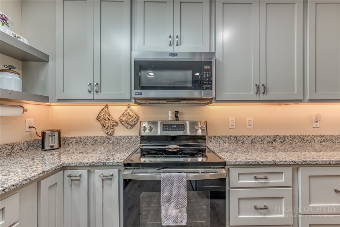 174 Spruce Pine Road Newland, NC 28657 - Photo 11 of 50 a kitchen with granite countertop cabinets and stainless steel appliances