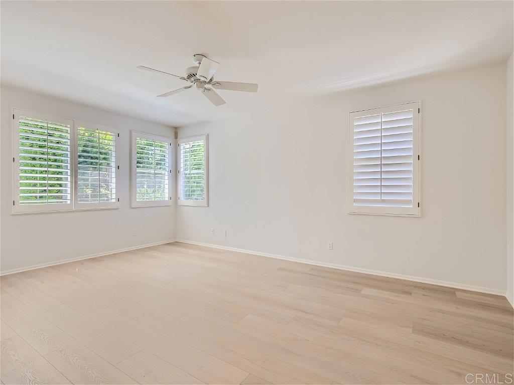 6562 Windflower Drive Carlsbad, CA 92011 - Photo 14 of 28 an empty room with windows and fan