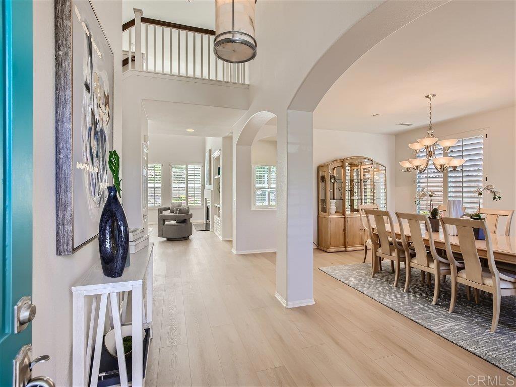 6562 Windflower Drive Carlsbad, CA 92011 - Photo 3 of 28 a view of a dining room with furniture window and wooden floor