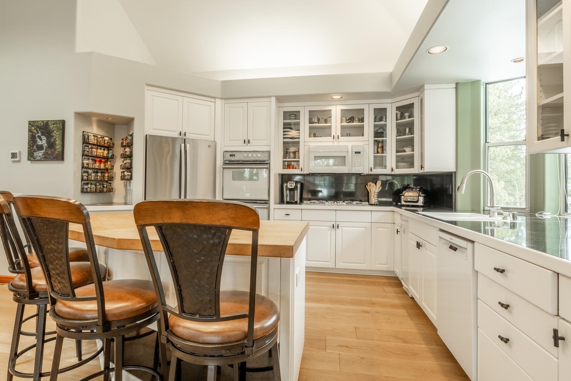 244 Ridge Way Mammoth Lakes, CA 93546 - Photo 19 of 49 Kitchen featuring butcher block counters, a breakfast bar area, stainless steel appliances, white cabinetry, and recessed lighting