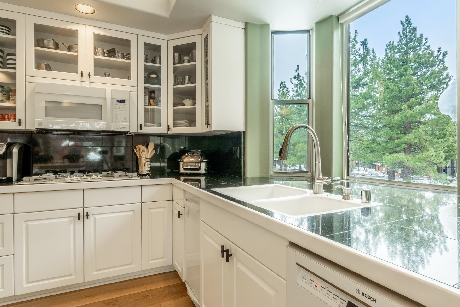 244 Ridge Way Mammoth Lakes, CA 93546 - Photo 20 of 49 Kitchen featuring white cabinets, backsplash, white appliances, and tile counters