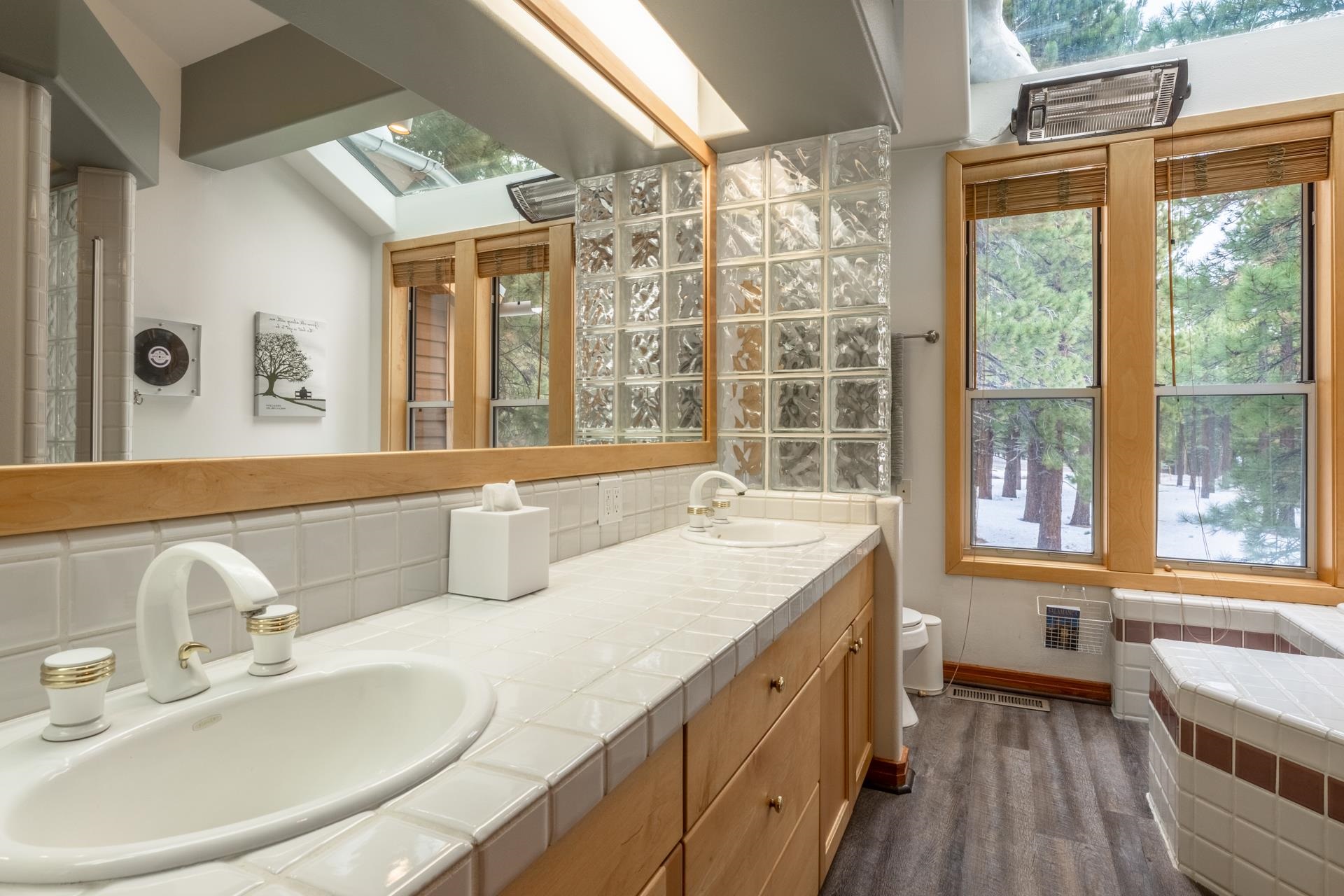 244 Ridge Way Mammoth Lakes, CA 93546 - Photo 32 of 49 Full bathroom with a skylight, double vanity, and decorative backsplash