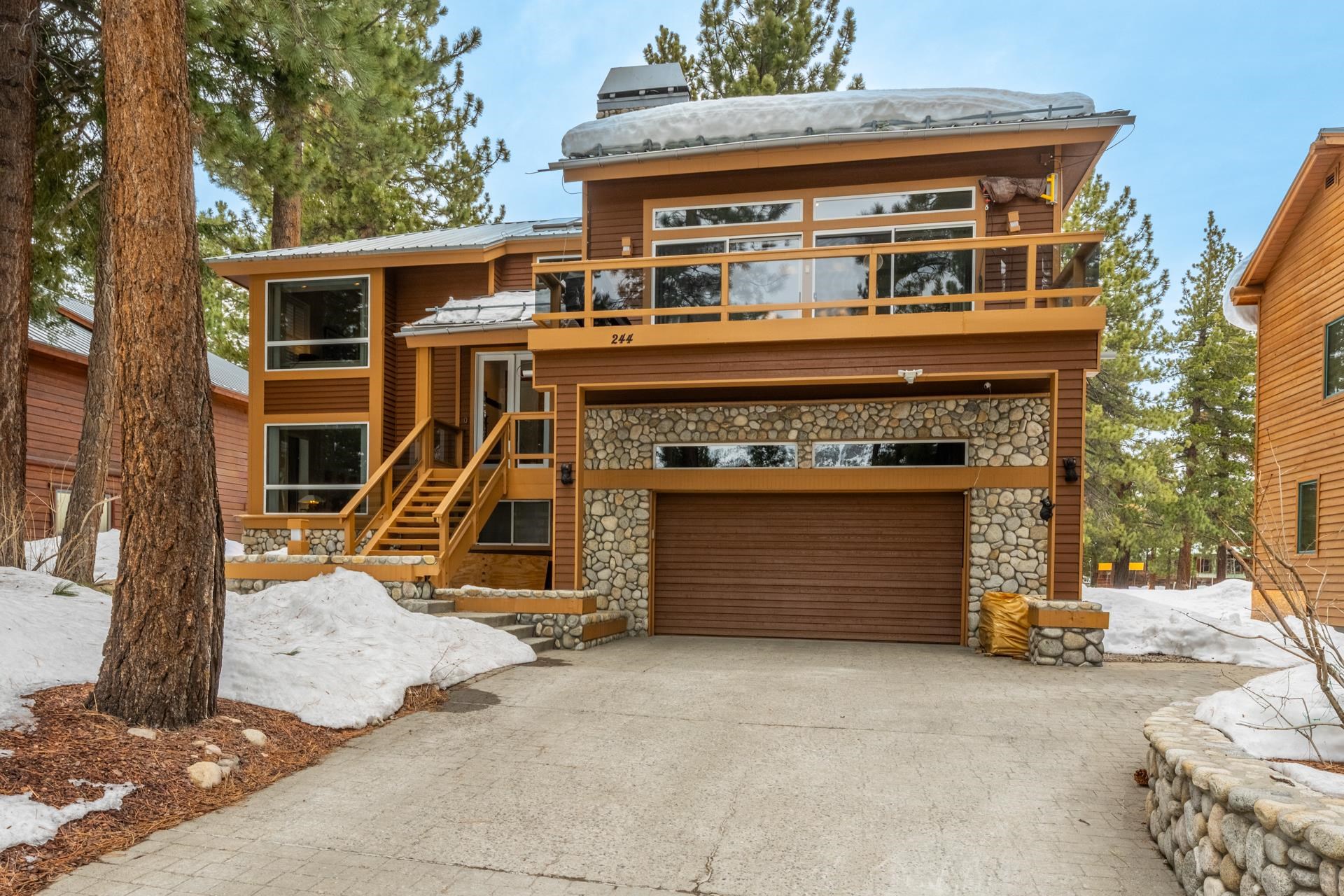 244 Ridge Way Mammoth Lakes, CA 93546 - Photo 4 of 49 Contemporary home featuring stone siding, a garage, and concrete driveway