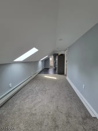 an empty room with windows and fireplace