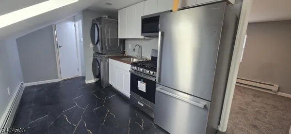 a kitchen with stainless steel appliances a refrigerator and a stove top oven