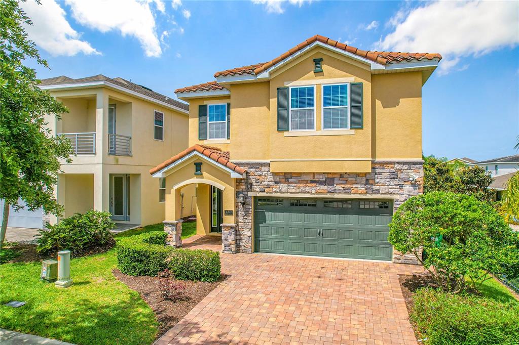 450 Novi Path Kissimmee, FL 34747 - Photo 1 of 1 a front view of a house with a yard and garage