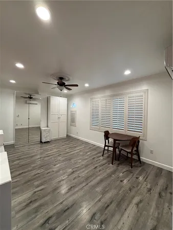 an empty room with wooden floor and furniture