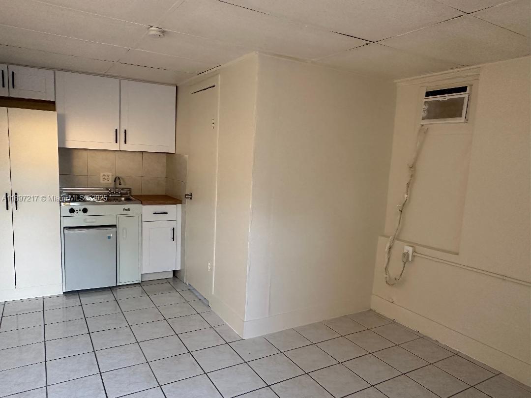 1956 Lincoln Street, Unit 10 Hollywood, FL 33020 - Photo 7 of 9 a utility room with cabinets washer and dryer
