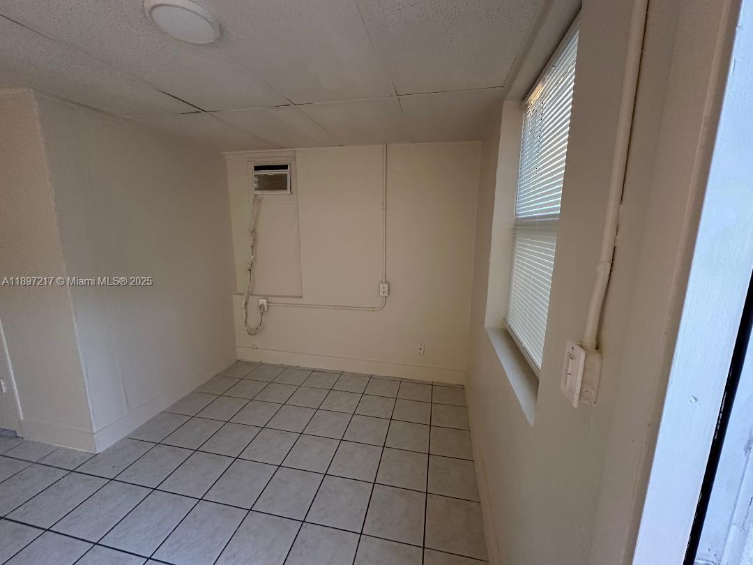 1956 Lincoln Street, Unit 10 Hollywood, FL 33020 - Photo 8 of 9 a view of an empty room and window