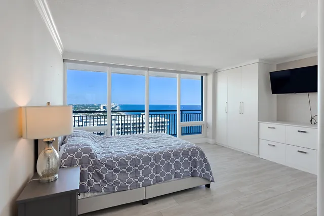 a bedroom with a large bed and a tv