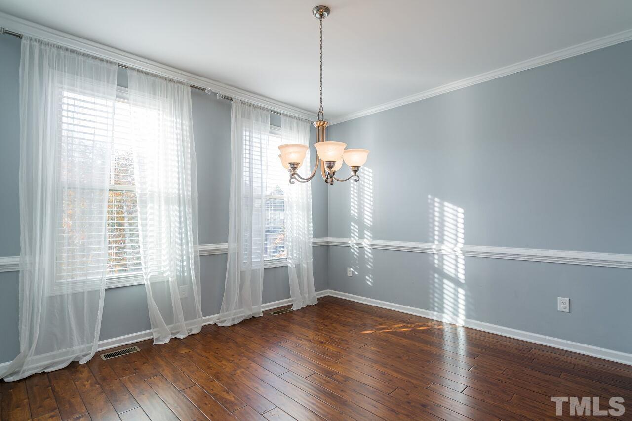 1323 Rodessa Run Raleigh, NC 27607 - Photo 14 of 29 a view of a room with wooden floor and windows