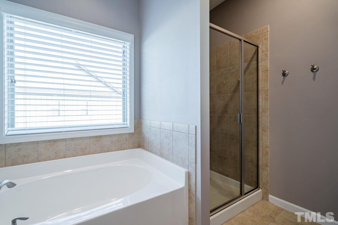 1323 Rodessa Run Raleigh, NC 27607 - Photo 25 of 29 a bathroom with a bathtub and a shower
