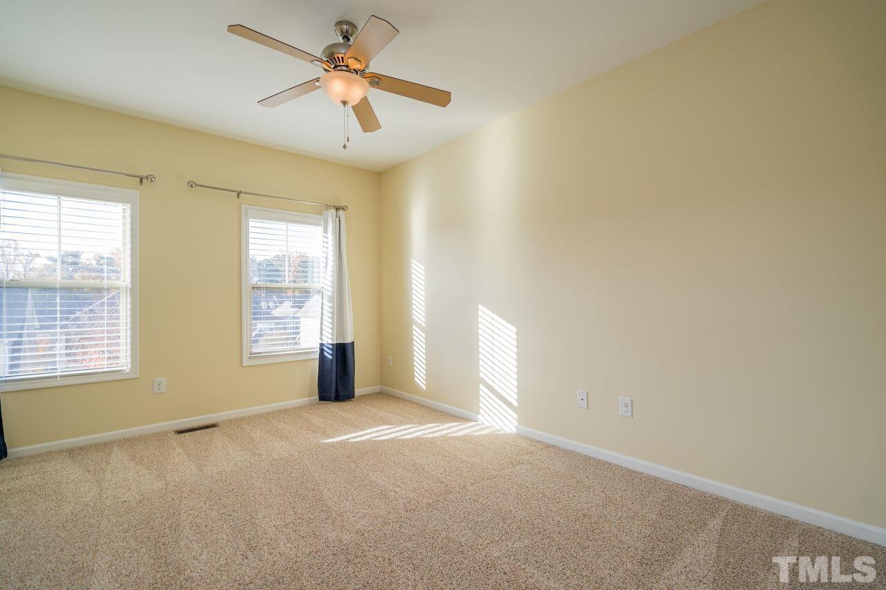 1323 Rodessa Run Raleigh, NC 27607 - Photo 26 of 29 an empty room with windows and fan
