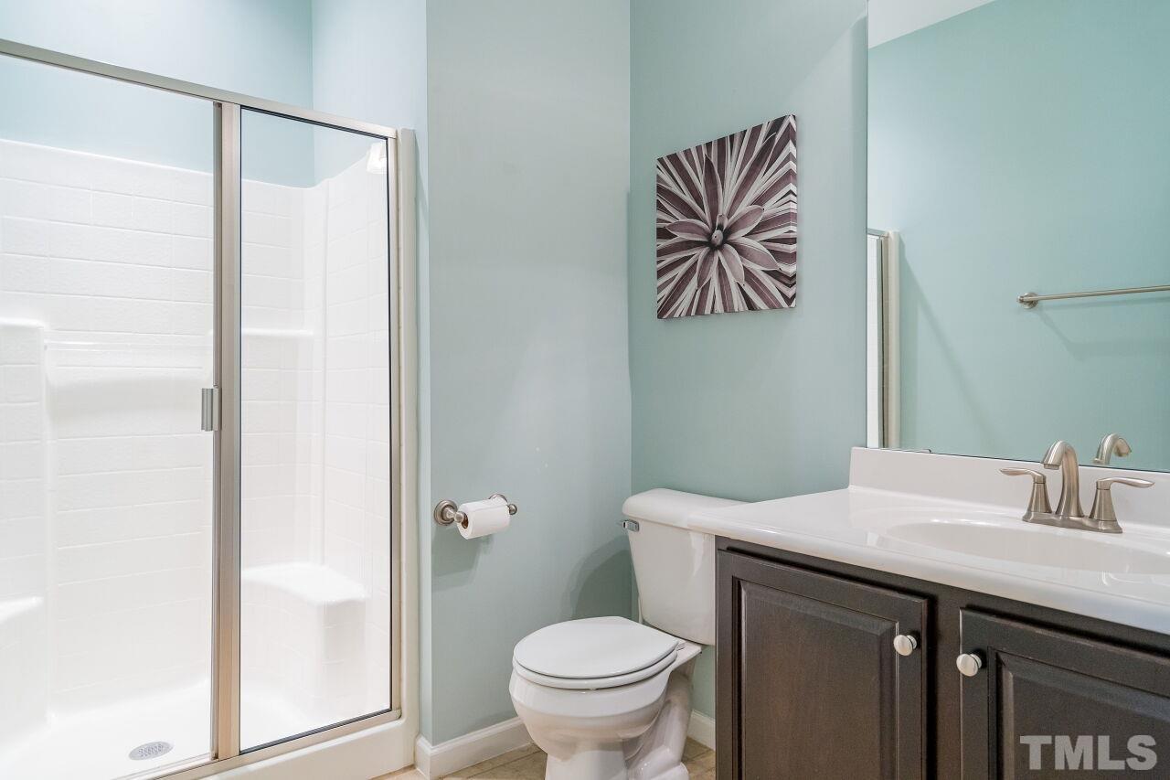 1323 Rodessa Run Raleigh, NC 27607 - Photo 7 of 29 a bathroom with a toilet a sink and a mirror
