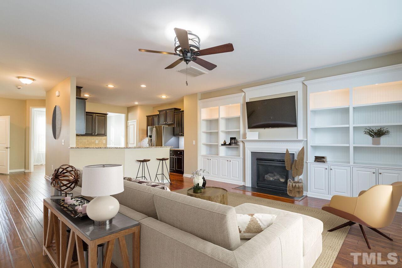 1323 Rodessa Run Raleigh, NC 27607 - Photo 10 of 29 a living room with furniture a fireplace and a flat screen tv