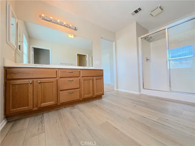 a spacious bathroom with a double vanity sink and a mirror