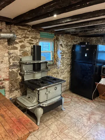 a stove top oven sitting inside of a kitchen