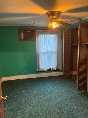 a view of a room with a wooden door
