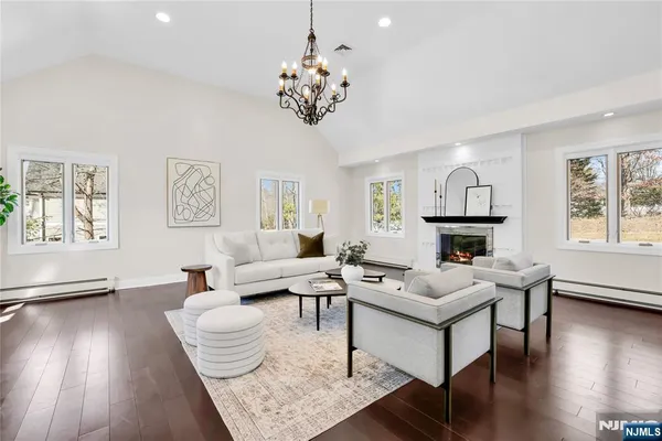 a living room with fireplace furniture and a wooden floor