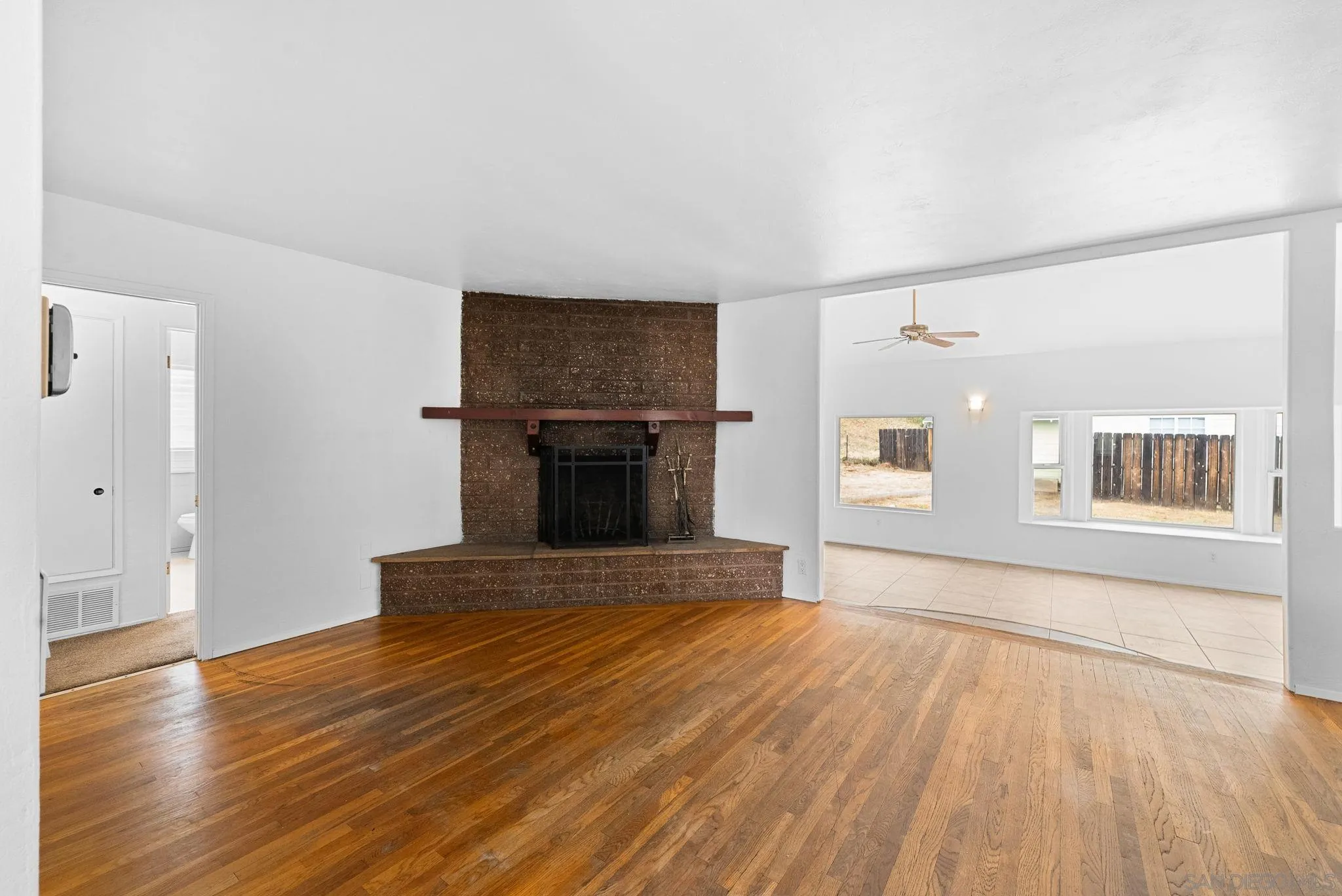 11507 Pinehurst Drive Lakeside, CA 92040 - Photo 12 of 25 a view of empty room with wooden floor and fireplace
